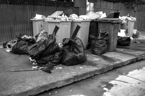Builders placing a skip at a construction site in Millbank