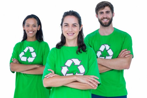 Different types of waste being loaded into a skip